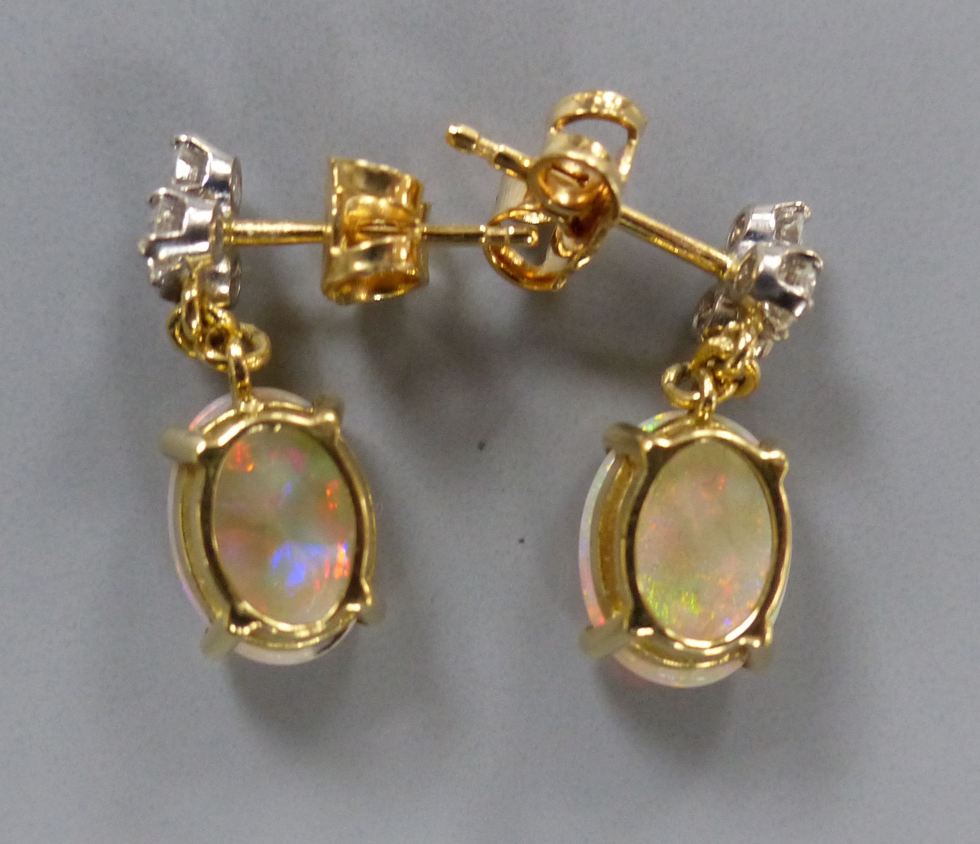 A modern pair of yellow metal, white opal and diamond set drop earrings, 17mm, gross 3.1 grams.